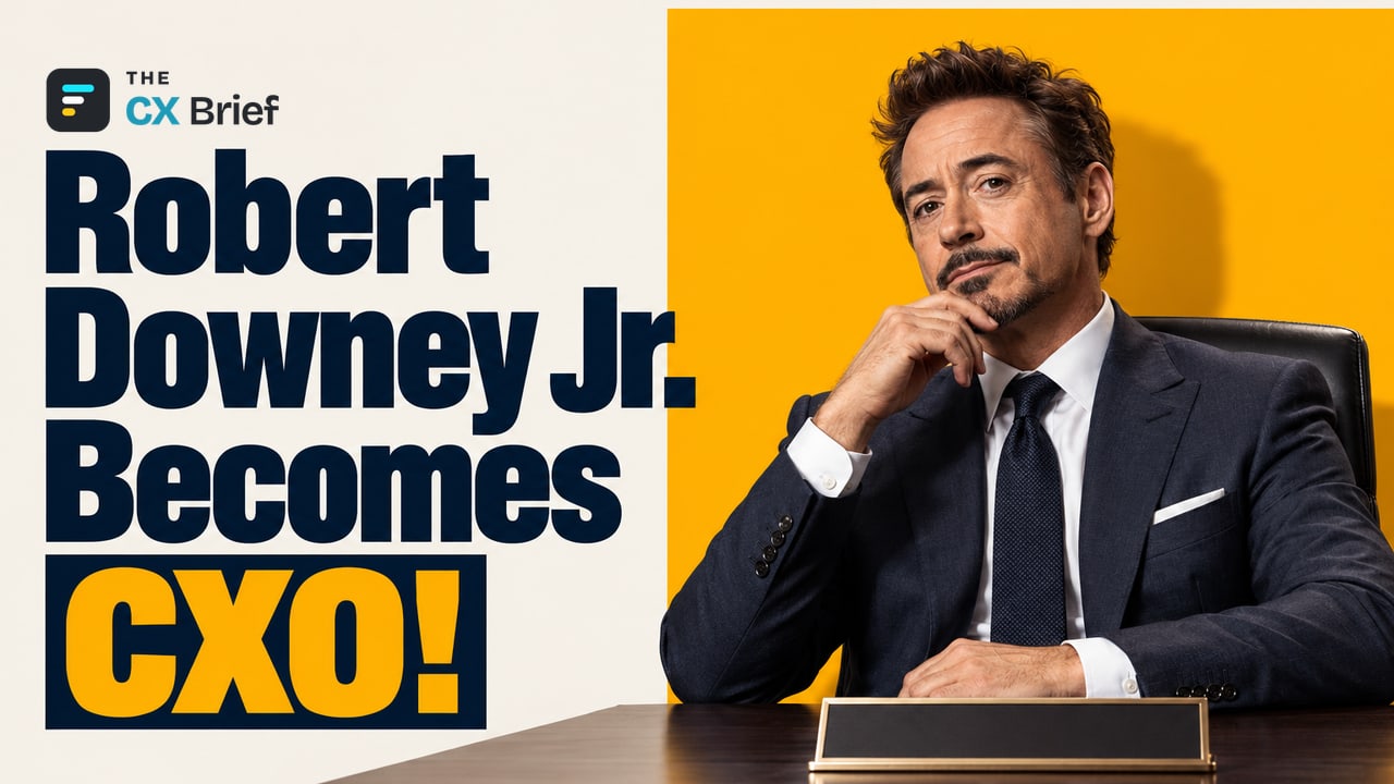 Robert Downey Jr. Becomes CXO! — Snap appoints Robert Downey Jr. as honorary Chief Customer Experience Officer for SPECS. Robert Downey Jr., in a dark suit, sits at a desk behind a nameplate, hand on his chin.